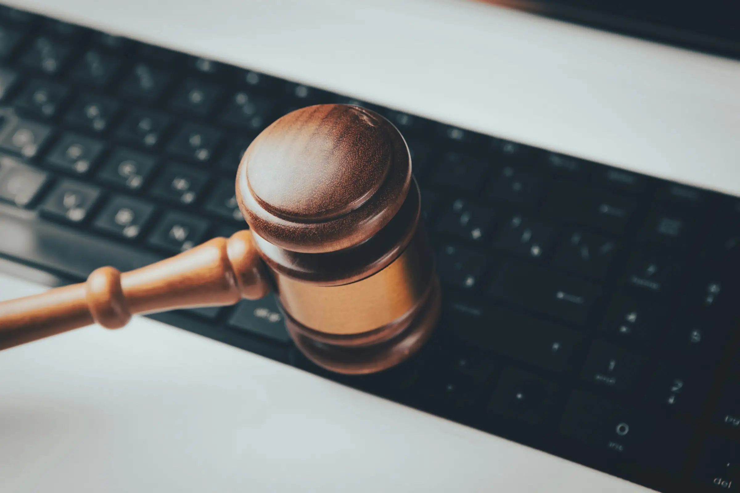 Wooden gavel resting on a computer keyboard