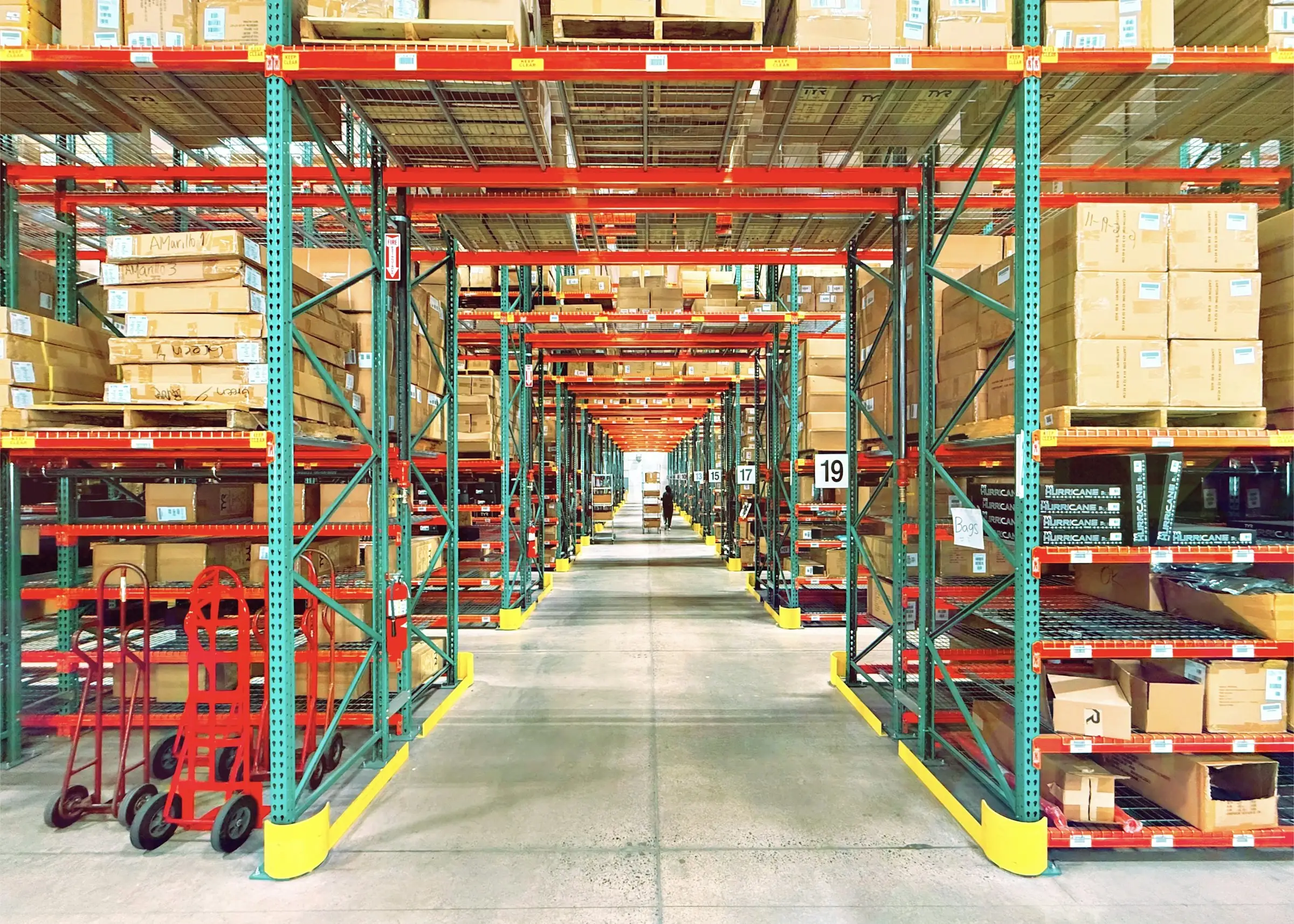 Warehouse aisle lined with pallet racking and boxed inventory