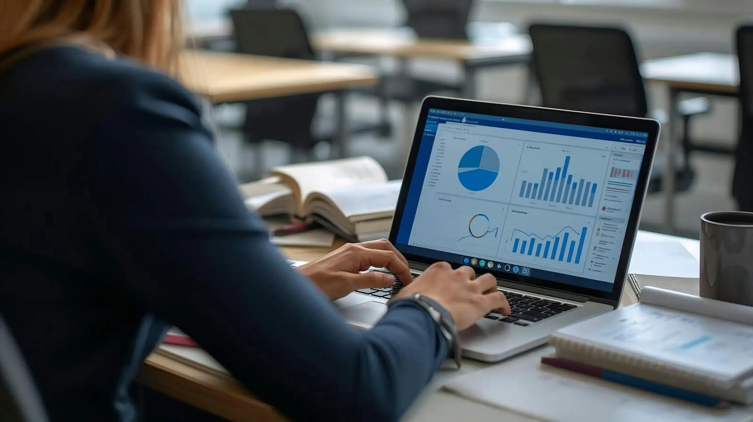 Marketer reviewing analytics charts on a laptop at her desk