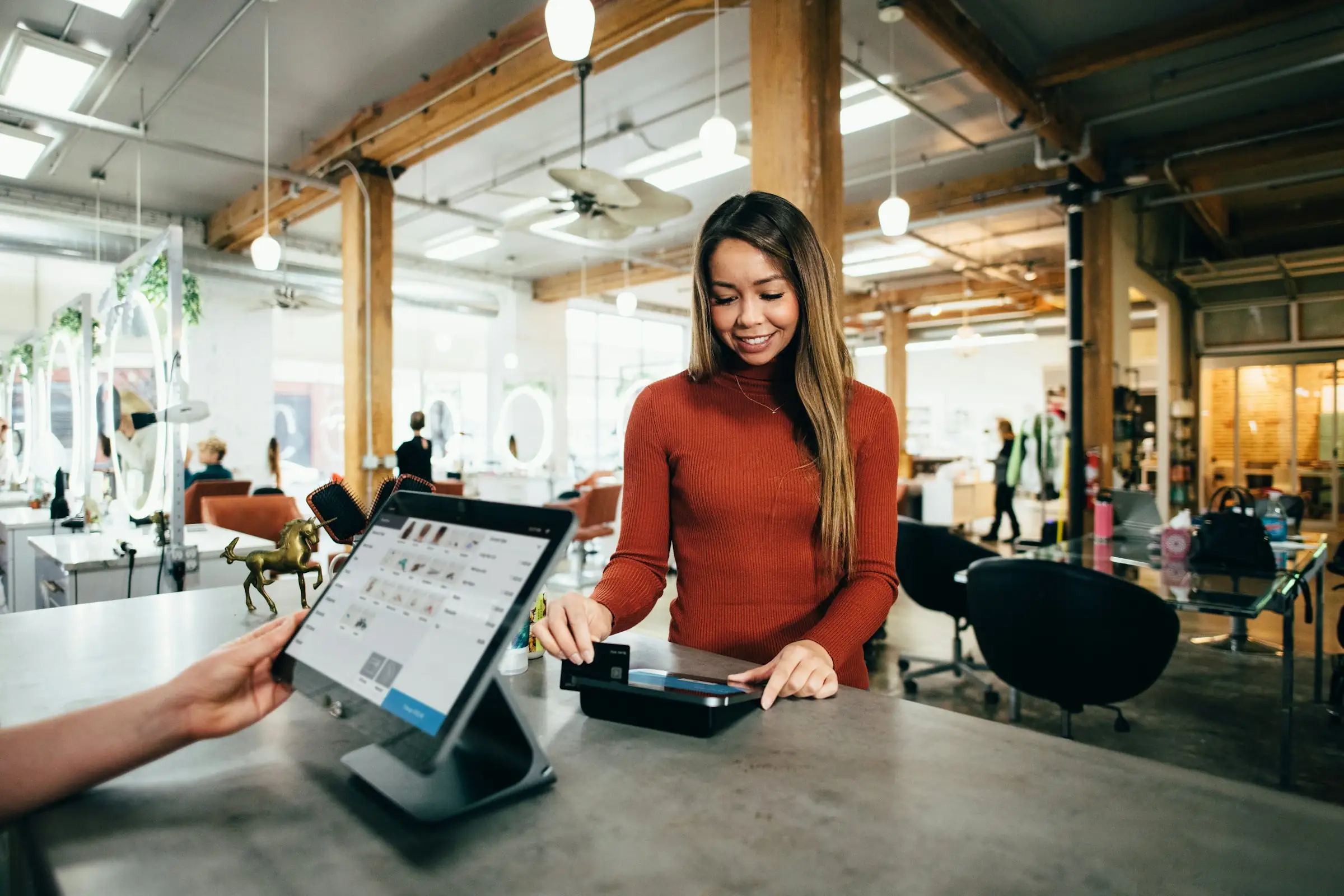 Customer checking out at a tablet point-of-sale counter in a retail store